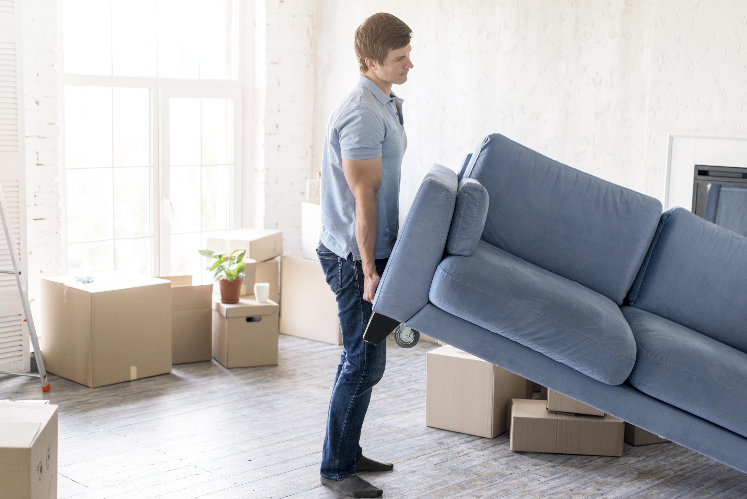 side-view-man-handling-couch-while-preparing-move-out